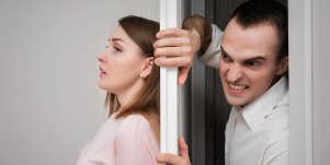 Young woman in horror trying to hide from her boyfriend