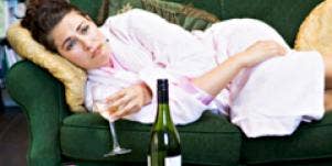 Woman drinking wine on couch