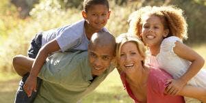 parents giving kids piggyback ride