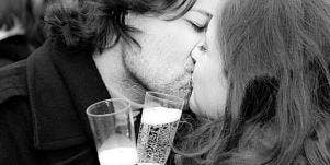 a couple kissing with champagne