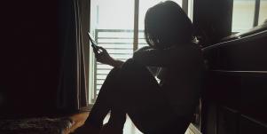 woman sitting in the dark