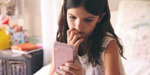 young girl looking at phone