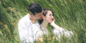 couple in a field sitting