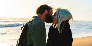 man kissing woman on beach
