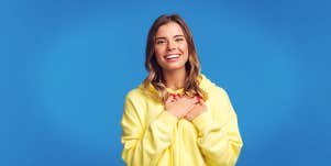 woman holding hands to her heart