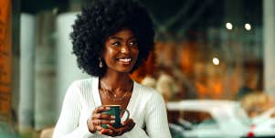 attractive smiling woman holding coffee