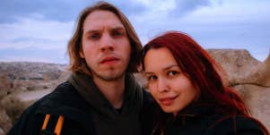 man and woman taking selfie in canyon
