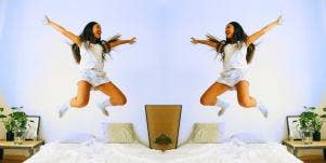 woman in the air jumping on bed 