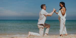 man proposing to woman on the beach