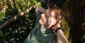 man relaxing on tree