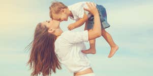 mom holding son in the air