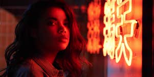 woman standing in neon light