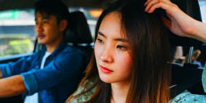 unhappy woman in car with boyfriend