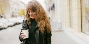 smiling woman holding coffee