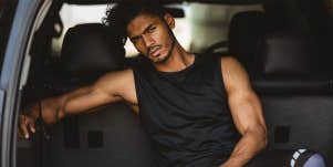 attractive fit man sitting in back of car