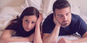 couple looks boarded on bed