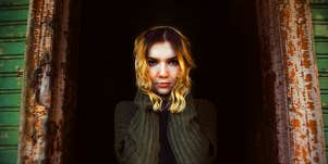 dramatic woman standing in dark alley