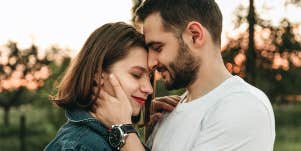 man embracing woman
