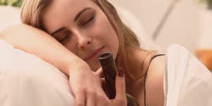woman holding a bottle in bed