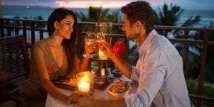 couple enjoying romantic dinner by the beach