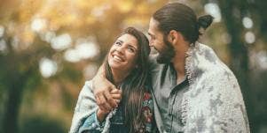 man and woman embracing in forest