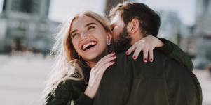 man kissing woman