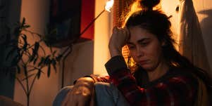 woman sitting alone in bedroom