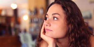 distracted girl with hand on chin thinking