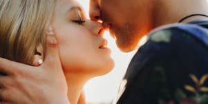 man kissing woman