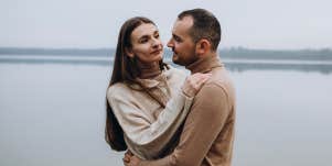 couple posing by water