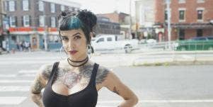 woman in low-cut tanktop and blue hair