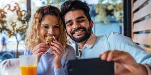 man and woman taking selfie at breakfast
