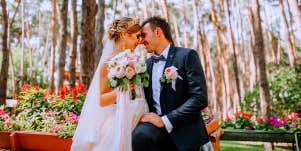 bride and groom sitting in garden