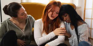 two women comforting sad friend
