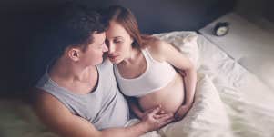 man hugging the pregnant woman