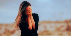 sad woman covering face
