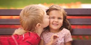 little boy kissing a little girl