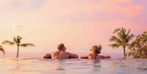 couples in the pool, looking at sunset
