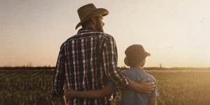 father and child looking at the sunset