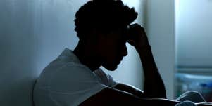 man sitting alone in the dark