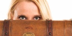 woman behind suitcase