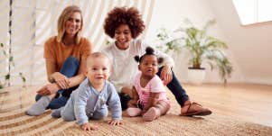 moms talking, watching their babies play