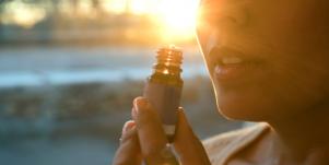 woman smelling essential oil