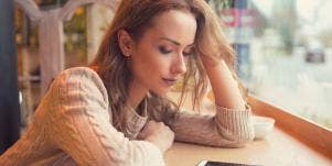 sad woman looking at her phone