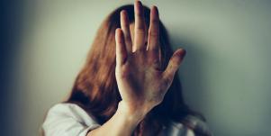 woman putting her hand to the camera