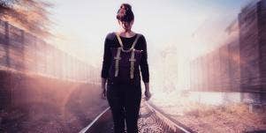 woman walking on train tracks