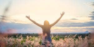 woman reaching out to sky