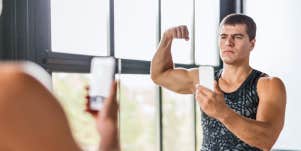 man with muscles looking in the mirror