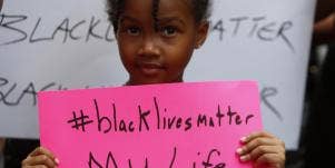 Black child holding a Black Lives Matter sign