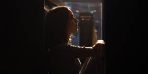 woman sitting in the dark